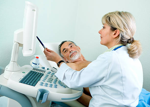 Senior patient getting ultrasound from doctor stock photo