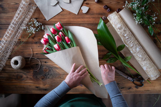 istock Woman Making A Bouquet Of Tulips 1209898968
