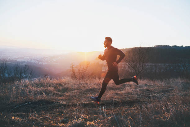 Side view of man running in the forest.