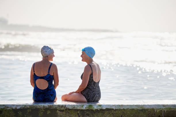 istock Enjoying a conversation after a swim 1209899041