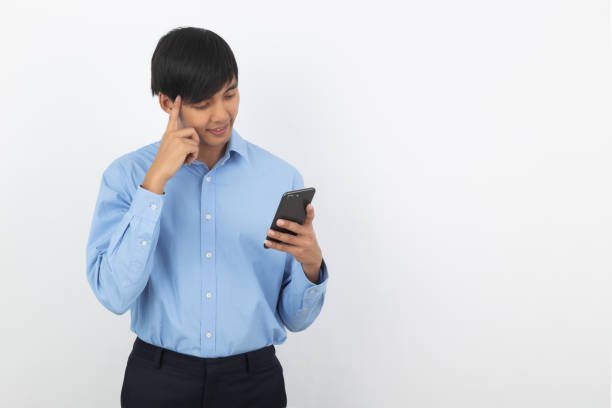 istock Young handsome asian business man playing smartphone with smiling isolated on white background 1209900791