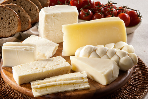 Different dairy products with bread and tomato