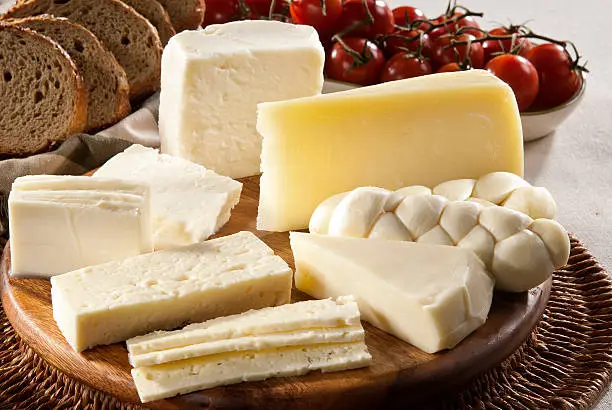 Photo of Different types of cheese, bread and tomatoes