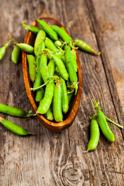 istock Green peas in a wooden bowl. 1209906669