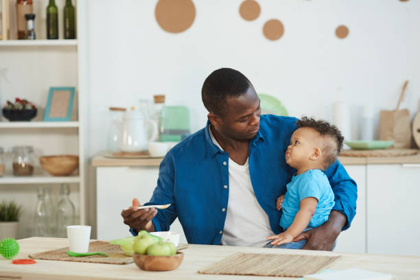 istock African-American Father Feeding Son 1209906673