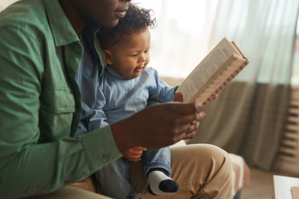 istock Father Reading Book to Baby 1209906695