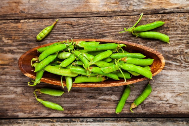 istock Green peas in a wooden bowl. 1209907576