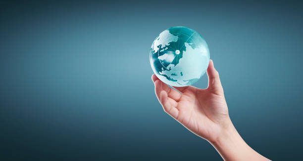 istock Globe ,earth in human hand, holding our planet glowing 1209907913