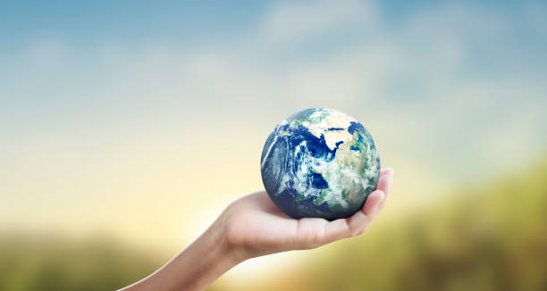 istock Globe ,earth in human hand, holding our planet glowing 1209907917