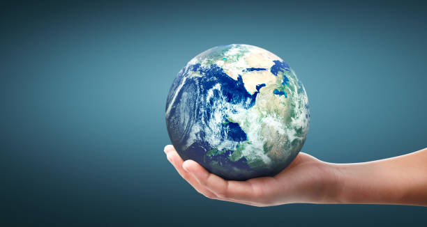 istock Globe ,earth in human hand, holding our planet glowing 1209907922