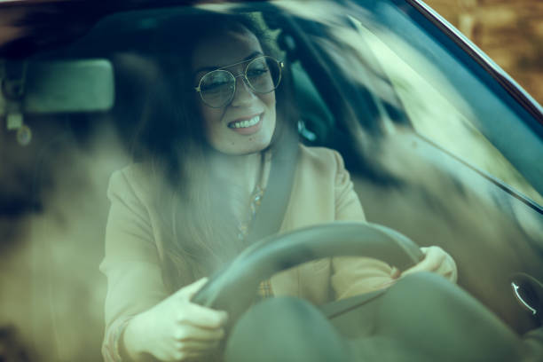 istock Young woman driving car 1209908052