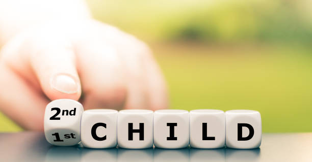 istock Expecting a second child. Hand turns dice and changes the expression 