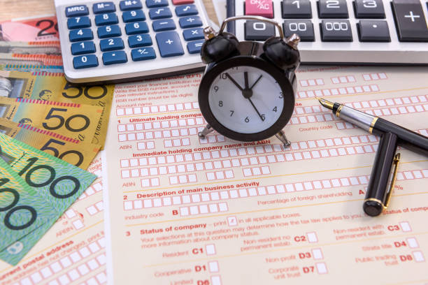 istock Clock and pen on australian tax form close up 1209908653