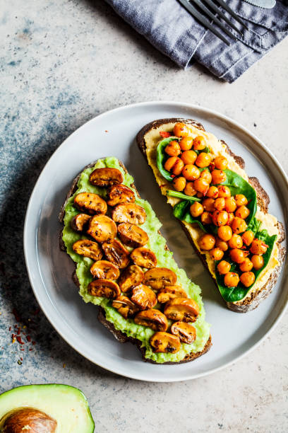 vegan toasts with guacamole and mushrooms, hummus with chickpeas on rye bread, top view. healthy vegan food concept. - food vegan food gourmet vegetarian food imagens e fotografias de stock