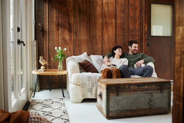 istock Content young couple talking over coffee on their sofa 1209910080