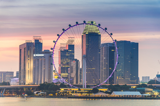 Singapore, 26 January 2024: Singapore Flyer against city skyline. Iconic landmark towering over urban landscape, capturing vibrant energy and modern architecture of Singapore