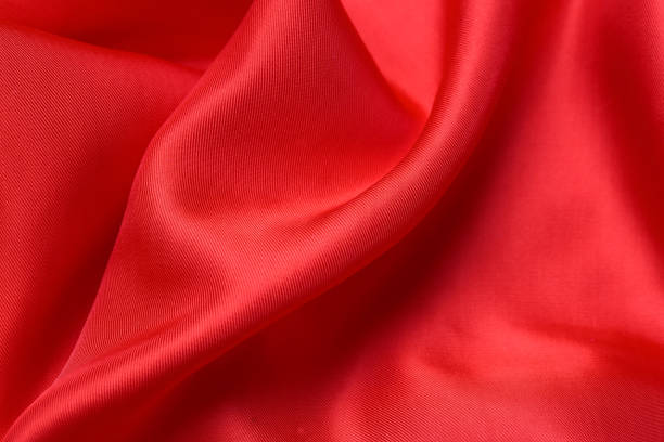istock fabric texture. abstract background with soft waves. Smooth elegant red silk or satin luxury cloth 1209911029