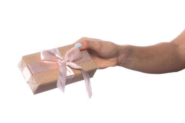 istock female hand holds a beautiful gift box with a bow isolated on white background 1209911153