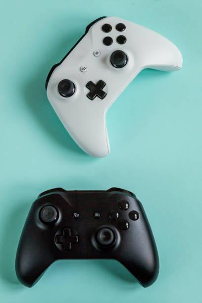 istock White and black two joystick gamepad, game console isolated on pastel blue colourful trendy background. Computer gaming competition videogame control confrontation concept. Cyberspace symbol 1209911487