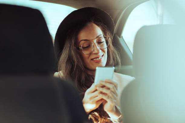 istock Woman using mobile phone in the car 1209913761