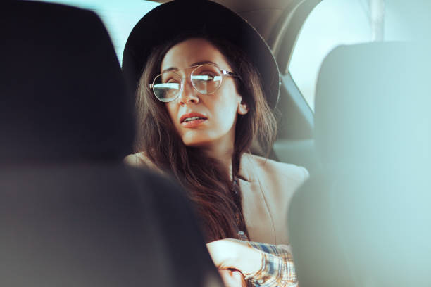 istock Woman using mobile phone in the car 1209914499