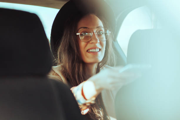 istock Woman using mobile phone in the car 1209915127