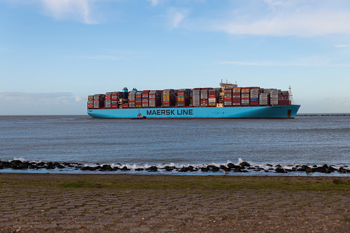 Rotterdam,Holland,01-march-2020:one of the biggest container ships entering rotterdam, the import of containers is reduced by the corona virus COVID-19, normal this ships enter more often