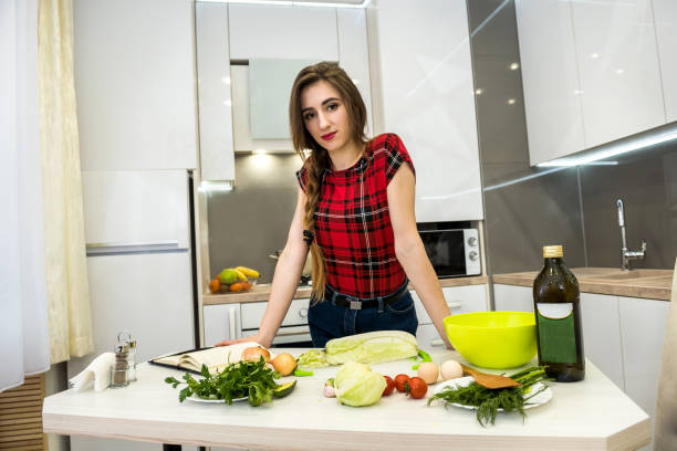 Young woman preparing dinner in a kitchen. healthy lifestyle.