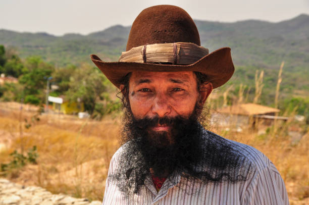 unique looking mixed race cowboy staring straight at camera