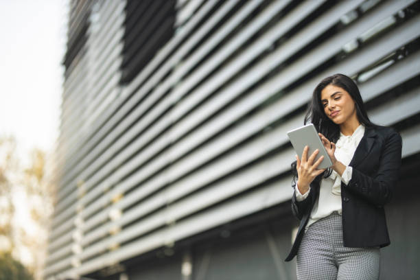 istock Cheerful businesswoman using digital tablet 1209920512