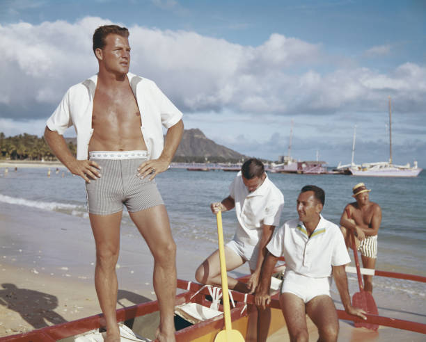 Friends standing in boat at beach  1964 stock pictures, royalty-free photos & images