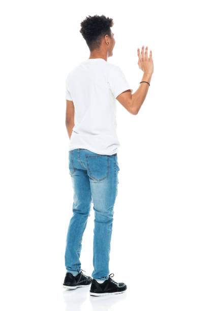 istock African ethnicity boys standing in front of white background wearing jeans 1209920848