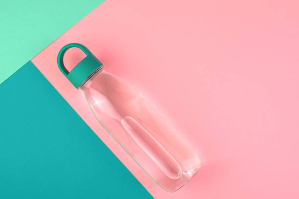 istock Abstract geometric background with one reusable water bottle at pink background. Minimalistic healthy lifestyle. 1209920853
