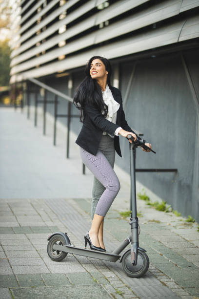 istock Businesswoman riding a scooter 1209921786