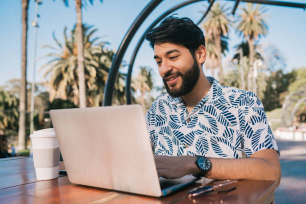 istock Young man using his laptop in a coffee shop. 1209921963