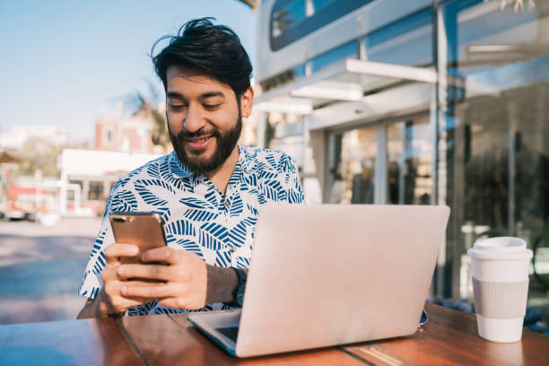 istock Young man using his laptop and mobile phone. 1209921977
