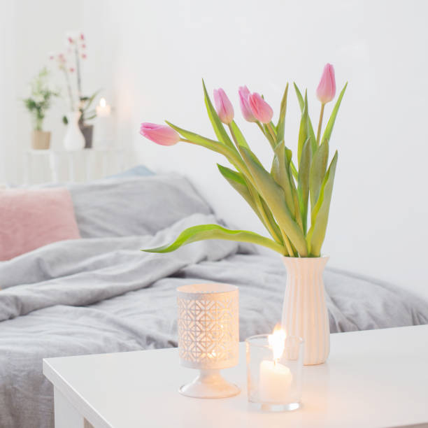 istock tulips in vase in cozy bedroom 1209922571