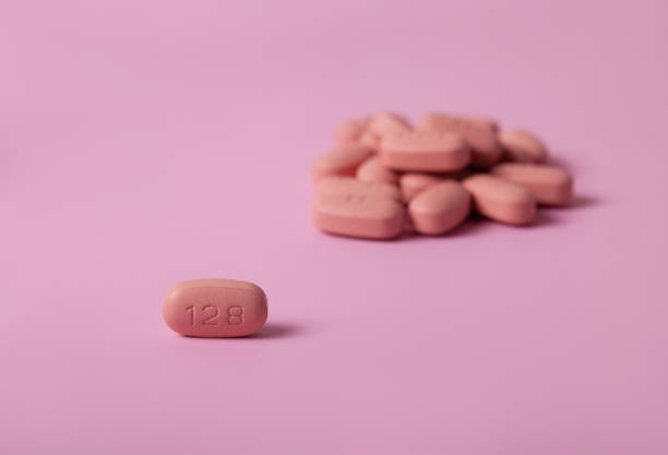 istock HIV/AIDS therapy pills on pink background 1209922710