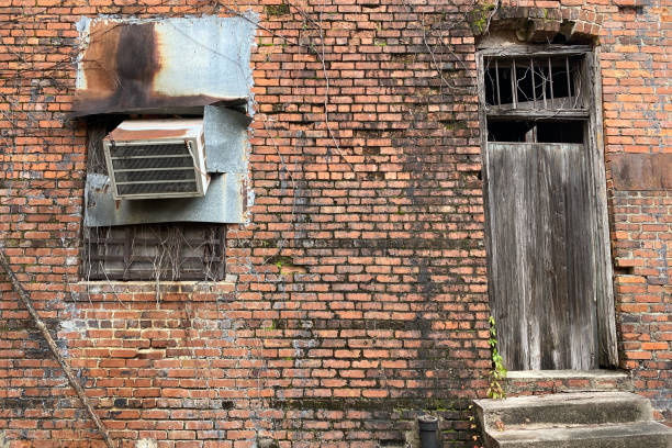 istock abandoned vintage office back door boarded up locked red brick building 1209923668