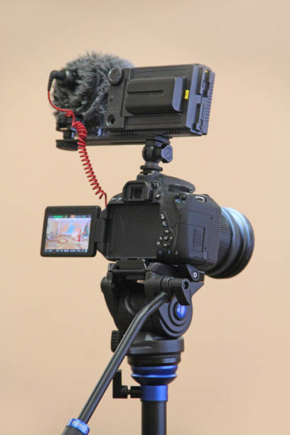istock Camera mounted on the tripod ready for shooting. Photographic equipment 1209923710