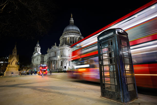 istock Traffic in London, typical red double decker bus passing fast 1209924737