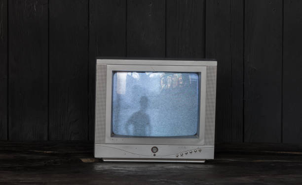 istock old tv on black wooden background 1209924846