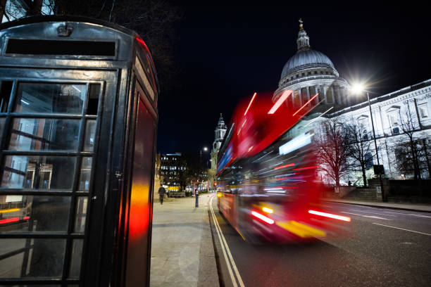 istock Traffic in London, typical red double decker bus passing fast 1209924852