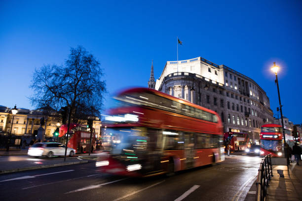 istock Traffic in London, typical red double decker bus passing fast 1209924970