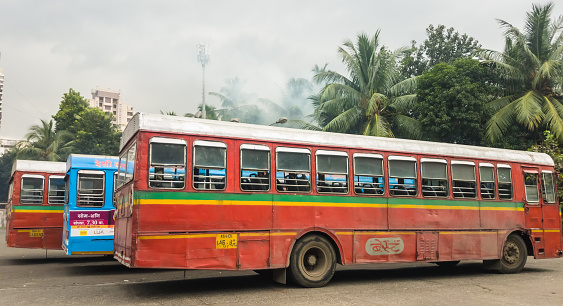 Mumbai, Maharashtra, India - November 2019: Three colorful BEST buses parked next to each other at the Kandivali East Bus Station.
