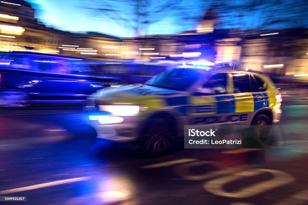 Police responding in London At night a car of the police passing fast in Trafalgar Square. Police Force Stock Photo