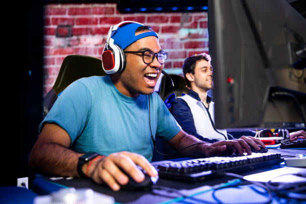 Young male esports gamers A young Hispanic man gaming with his friends gamer stock pictures, royalty-free photos & images