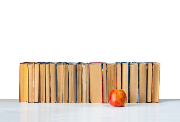 istock Stack of books and red apple isolated on a white background, back to school education concept 1209927351