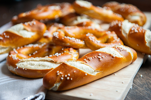 Closeup photo of handmade lye bun and bavarian pretzel in bakery