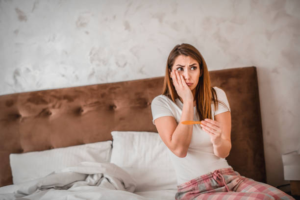 istock Young girl with unwanted pregnancy looking the test 1209927643